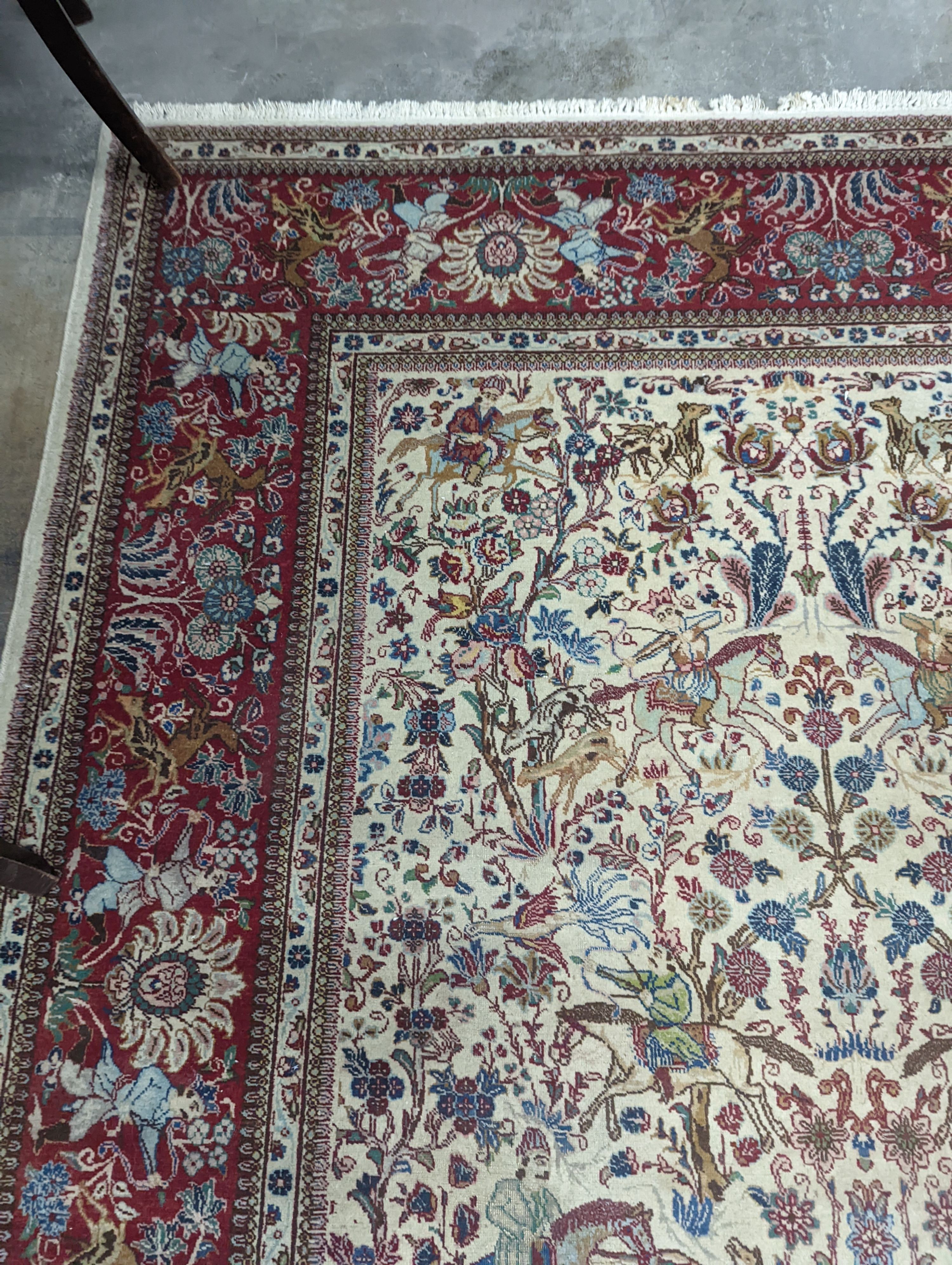 A Tabriz ivory ground pictorial rug (signed), 390 x 294cm